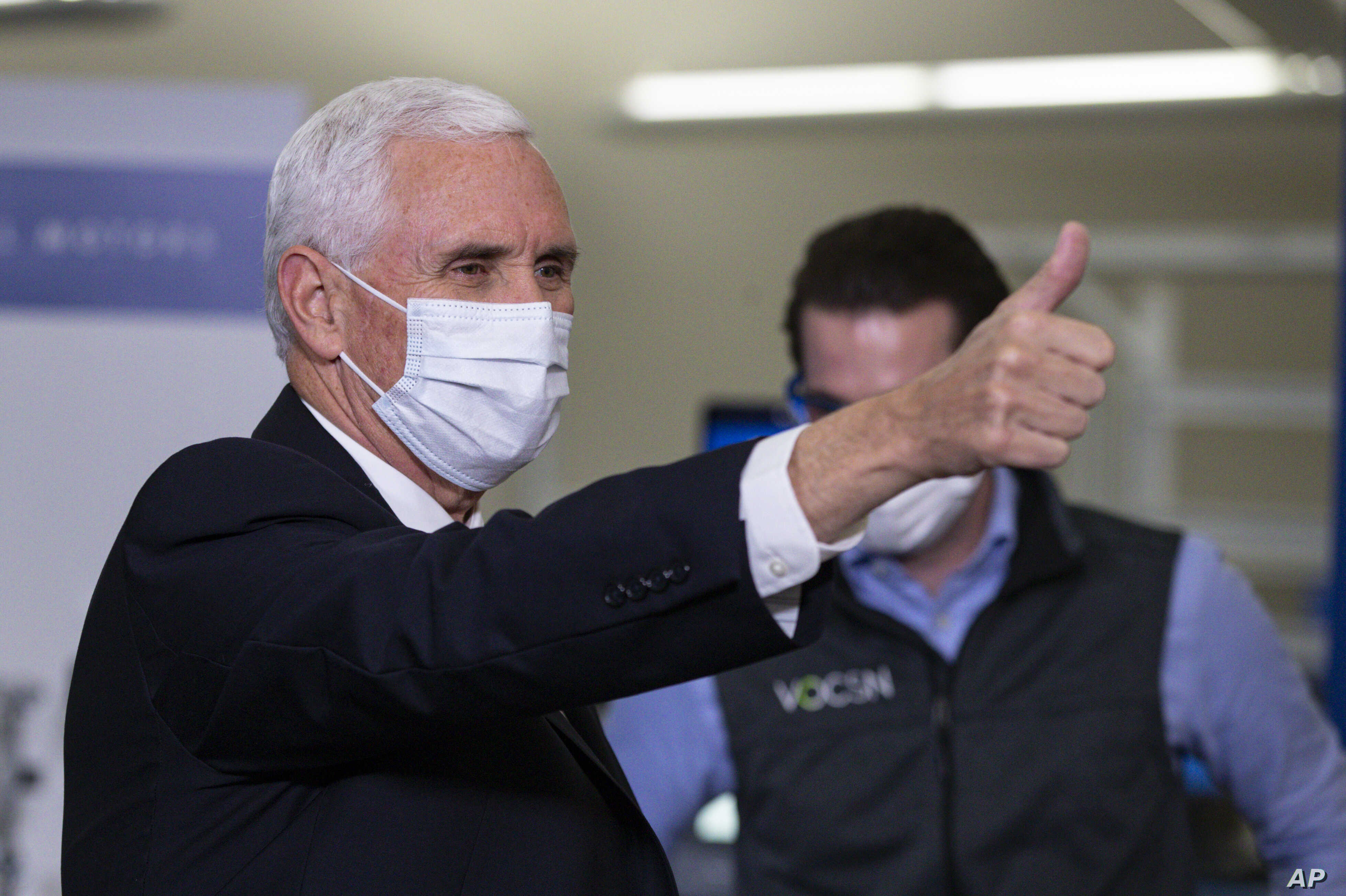 Vice President Mike Pence gestures while visiting the General Motors/Ventec ventilator production facility in Kokomo, Ind., Thursday, April 30, 2020. (AP Photo/Michael Conroy)